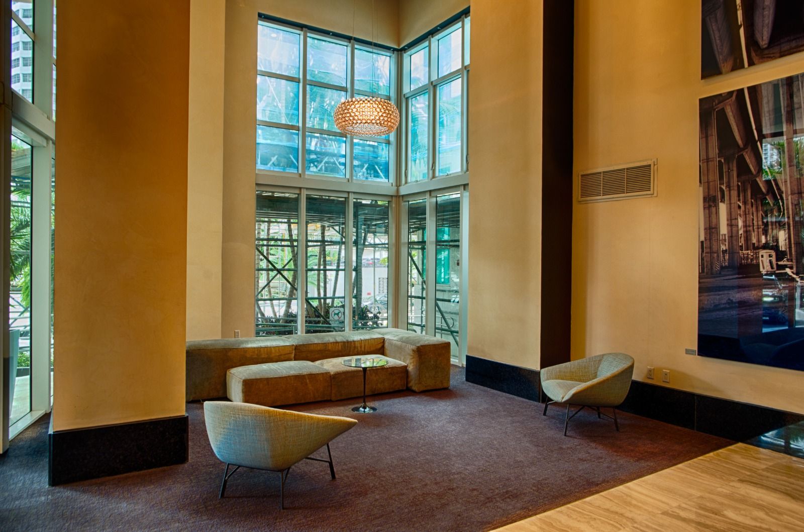 Finished residential lobby with polished stone floors and full-height glazing