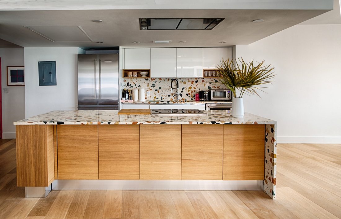 Remodelled kitchen with a timber island and terrazzo waterfall edge